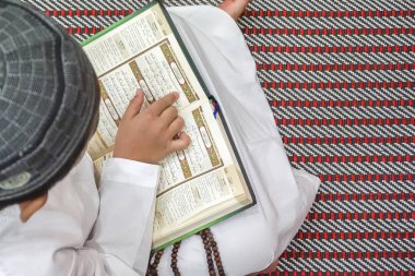 Al kuran oruç ayı boyunca (Ramazan) okuma çocuk. DOF ve kopya alanı.