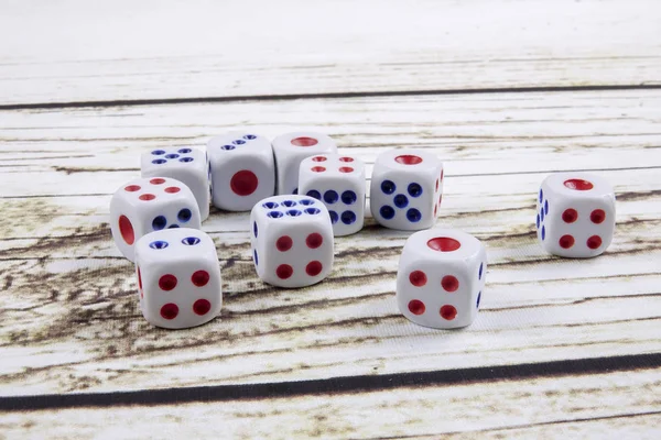 White dice on wooden background.  Concept of luck, chance and leisure fun.