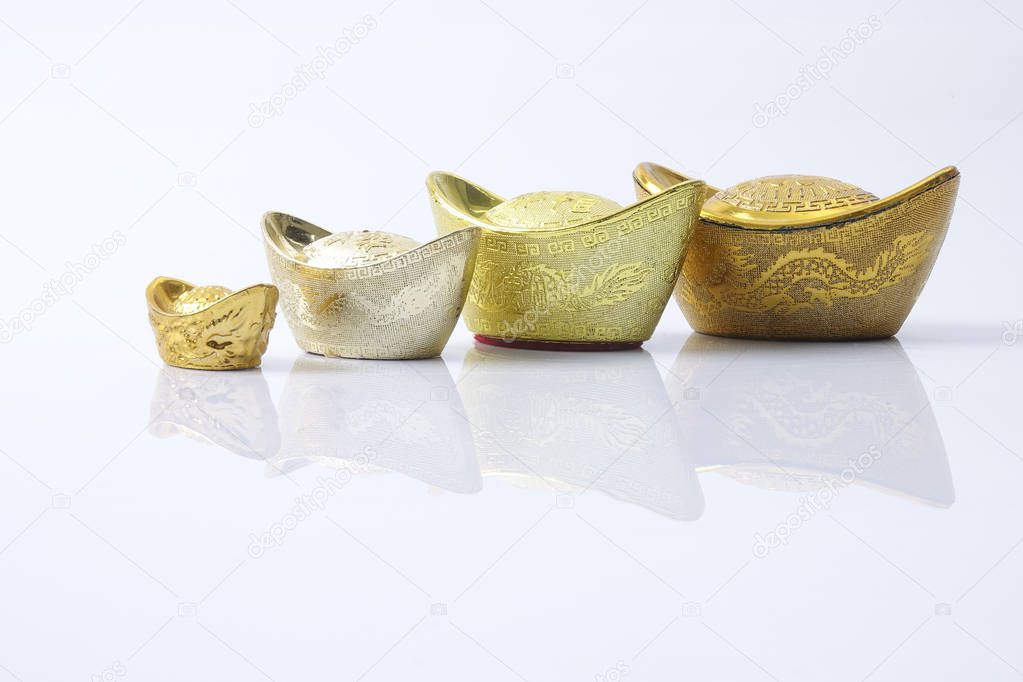 Chinese new year festival decorations,   gold ingots isolated on white. Chinese characters means luck,wealth and prosperity.