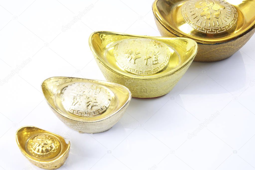 Chinese new year festival decorations,   gold ingots isolated on white. Chinese characters means luck,wealth and prosperity.