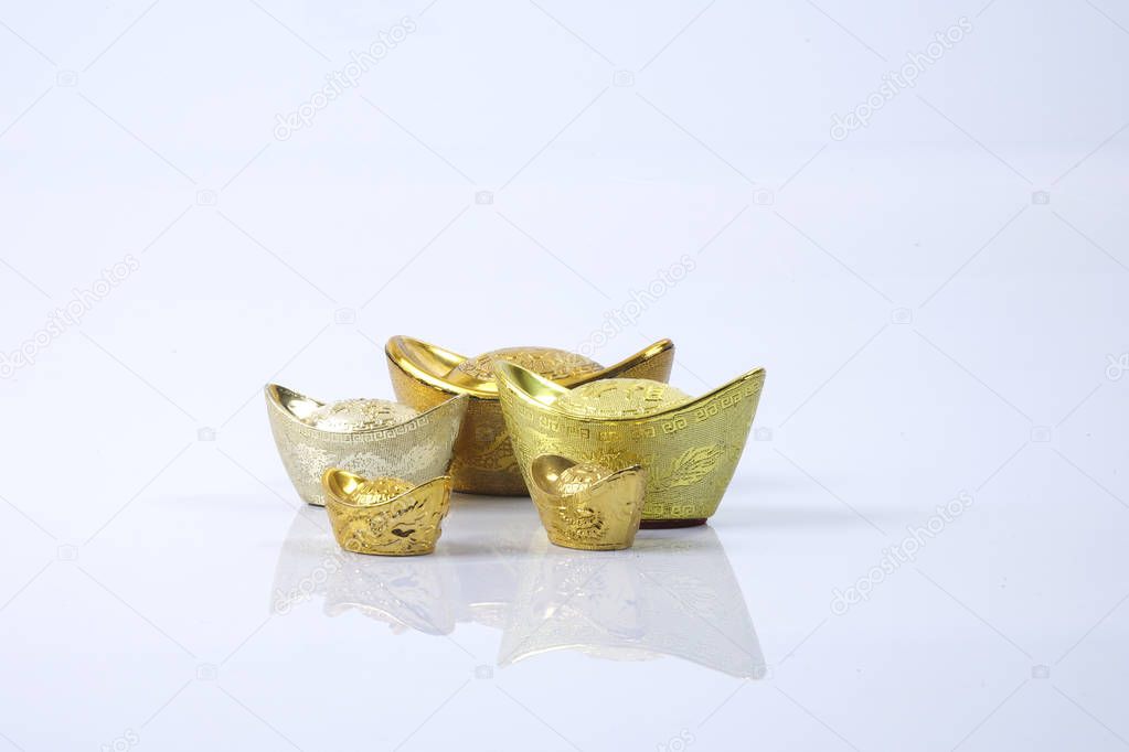 Chinese new year festival decorations,   gold ingots isolated on white. Chinese characters means luck,wealth and prosperity.