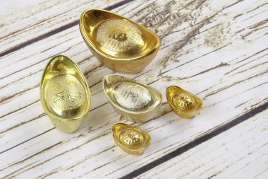 Altın külçeler ve kırmızı para paket için Çin yeni yılı ahşap arka plan üzerinde şenlikli. Şans, zenginlik ve resimde görüldüğü gibi refah Çince karakter anlamına gelir.