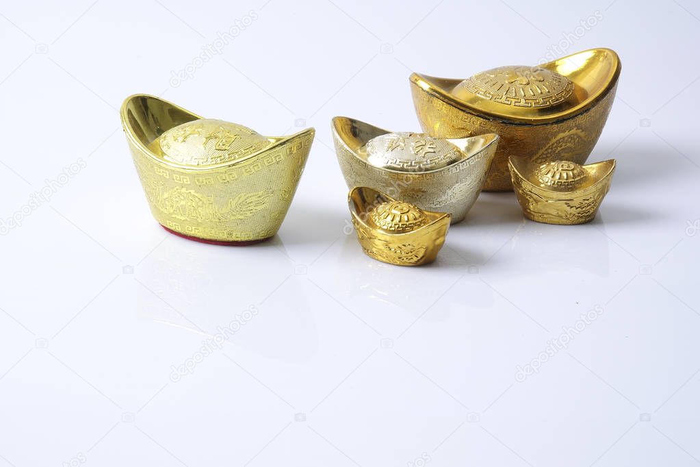 Chinese new year festival decorations,   gold ingots isolated on white. Chinese characters means luck,wealth and prosperity.