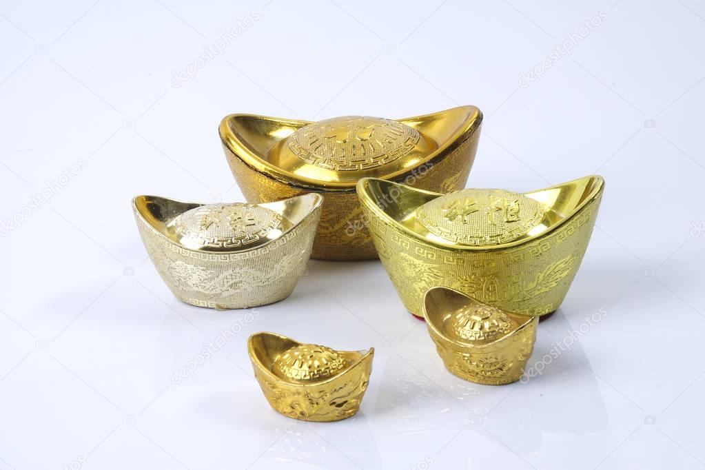 Chinese new year festival decorations,   gold ingots isolated on white. Chinese characters means luck,wealth and prosperity.