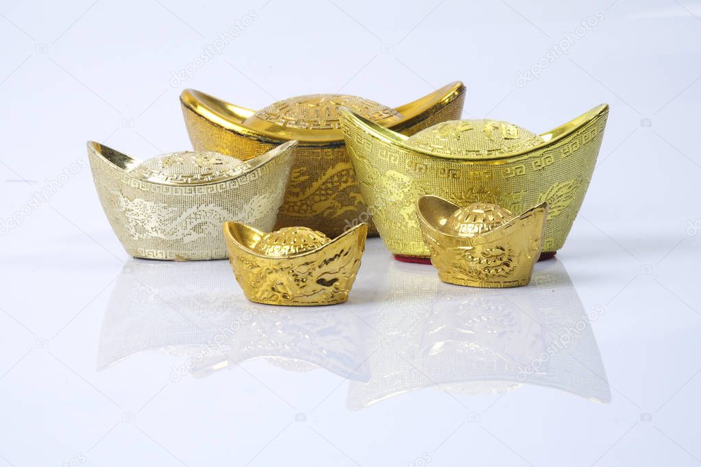 Chinese new year festival decorations,   gold ingots isolated on white. Chinese characters means luck,wealth and prosperity.