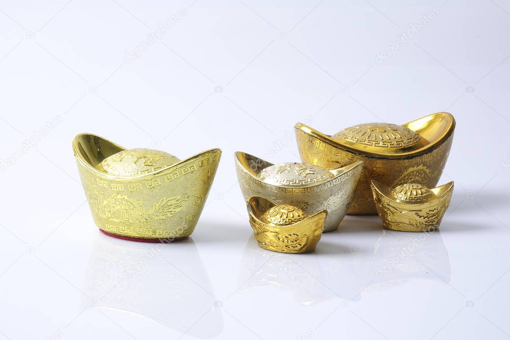 Chinese new year festival decorations,   gold ingots isolated on white. Chinese characters means luck,wealth and prosperity.