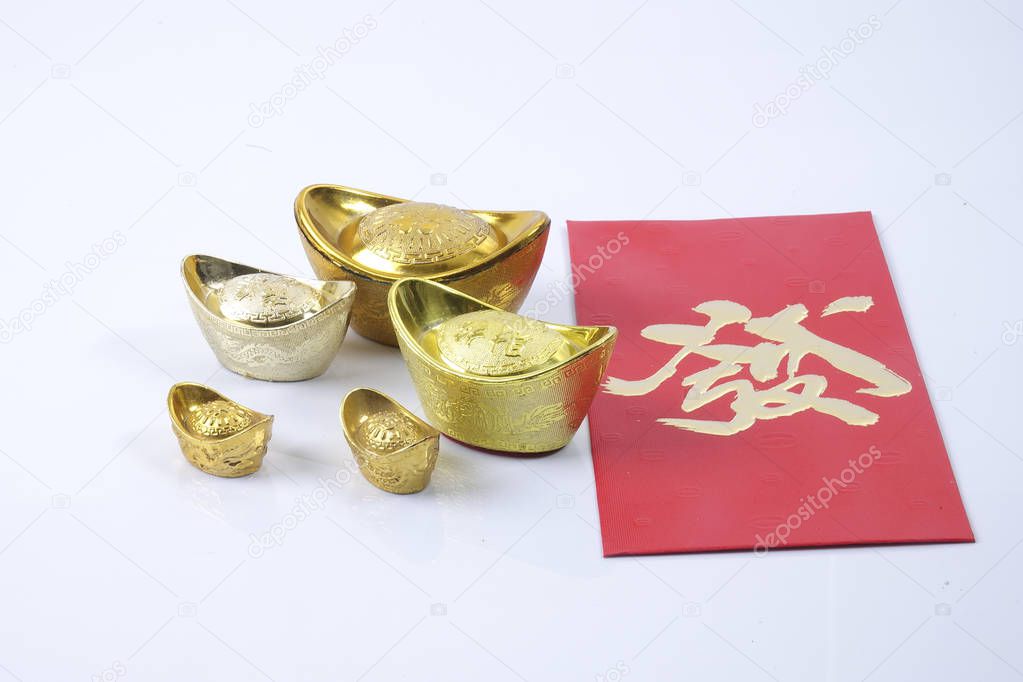 Chinese new year festival decorations, ang pow or red packet and gold ingots. Chinese characters means luck,wealth and prosperity.