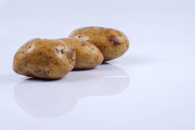 Beyaz arka planda taze çiğ patates.