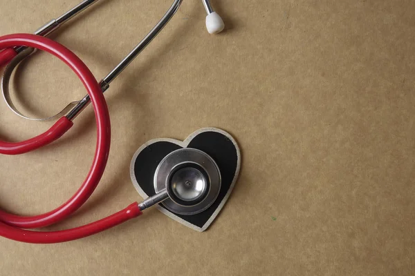 Красный стетоскоп на деревянном фоне. Медицинская и медицинская концепция . — стоковое фото