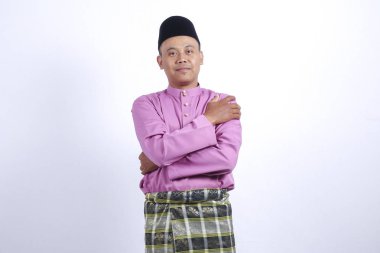 Adam akıllı telefon ile geleneksel giyim Eid Bayramı kutlamak.