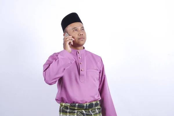 Az ember a hagyományos ruhát smartphone ünnepelni Eid Fitr. — Stock Fotó