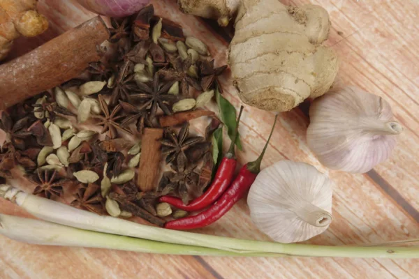 Mixture of cooking spices and herbs on a wooden table — Stock Photo, Image