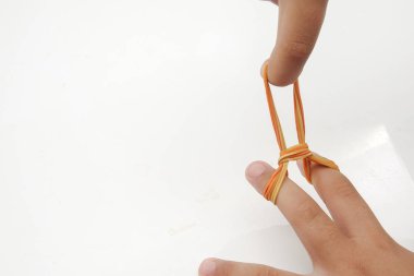 Elastik lastik bant üzerinde beyaz izole ellerinde