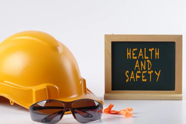 Yellow hardhat safety helmet,safety glass and ear plug isolated — Stock Photo, Image