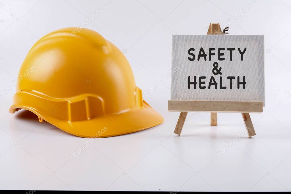 Yellow hardhat safety helmet on white background and SAFETY & HE