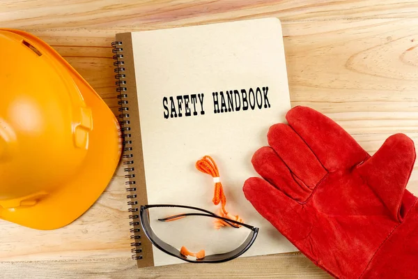 Safety hat,glove,glasses,ear plugs and note book. Health and safety concept.