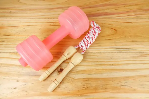 Etmek ve ahşap arka plan üzerinde ip atlama. Fitness ve sağlıklı yaşam konsepti.