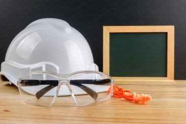 Sağlık ve emniyet konsepti. Ahşap masa siyah arka plan üzerinde kişisel koruyucu ekipman.