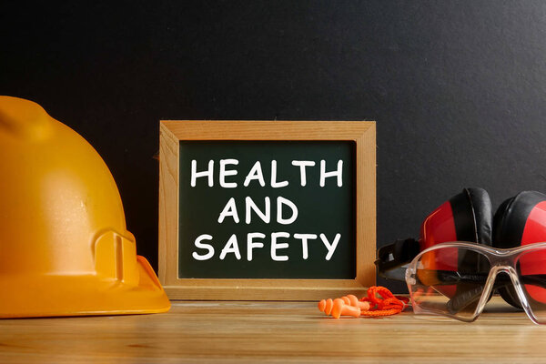 HEALTH AND SAFETY CONCEPT. Personal protective equipment on wood