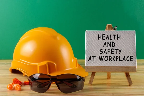 HEALTH AND SAFETY AT WORKPLACE CONCEPT. Yellow hardhat safety he