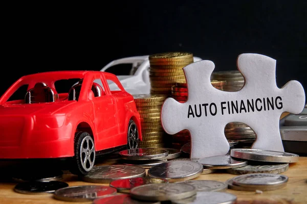 AUTO FINANCING CONCEPT : Small cars,coins,piece of puzzle and ca