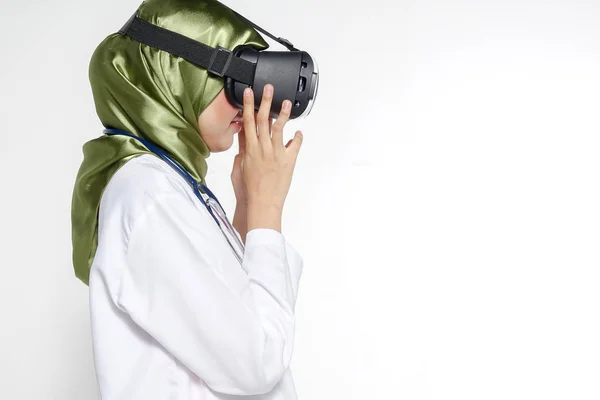 Female doctor wearing virtual reality glasses isolated on white background