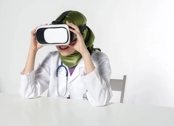 Female doctor wearing virtual reality glasses isolated on white background