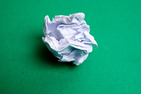 Crumpled paper ball on wooden table