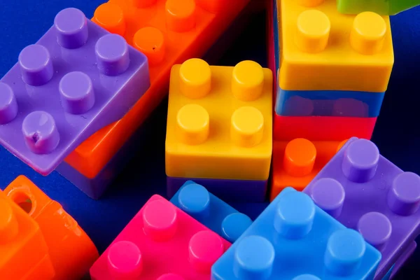 Plastic building blocks isolated on blue background