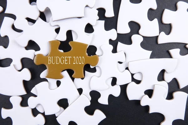 Budget 2020 printed on gold puzzle over white puzzle background