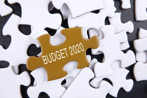 Budget 2020 printed on gold puzzle over white puzzle background