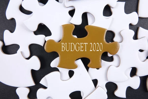 Budget 2020 printed on gold puzzle over white puzzle background