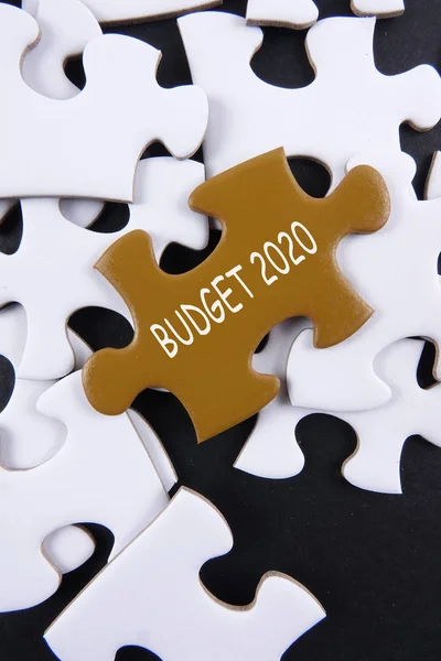 Budget 2020 printed on gold puzzle over white puzzle background