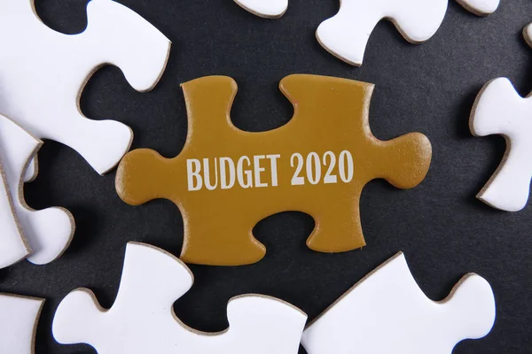 Budget 2020 printed on gold puzzle over white puzzle background