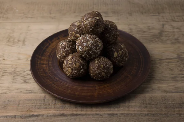 Oat, seed and nut energy balls on a wooden table