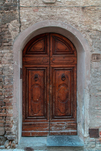 Old door in Florence in dark brown. Grunge background