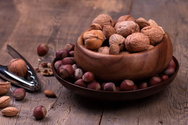Walnuts and hazelnuts on rustic wooden background — Stock Photo, Image