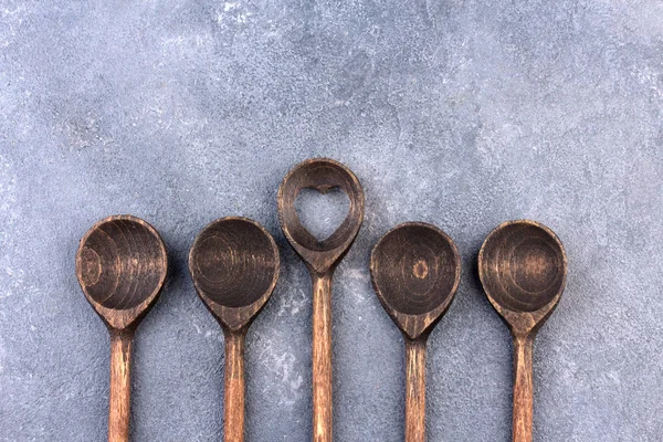 Wooden spoon over textured background, from above — Stock Photo, Image