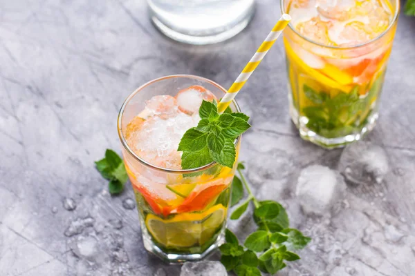 Cold refreshing summer lemonade in a glass on a grey concrete or stone background. — Stock Photo, Image