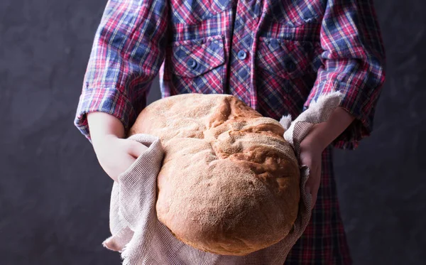 Little girl holding freshly baked crusty homemade ciabatta bread — Stock Photo, Image