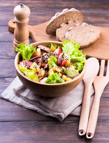 Meat salad on wooden table — Stock Photo, Image
