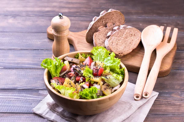 Meat salad on wooden table — Stock Photo, Image