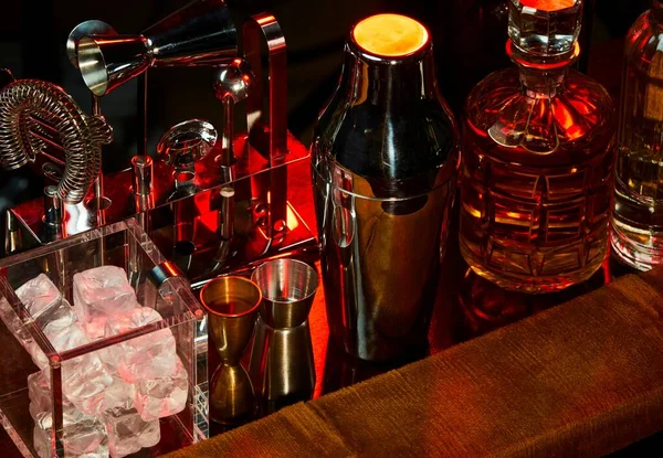 bar shakers and drinks on a table, Indoors bar counter with glasses and shakers