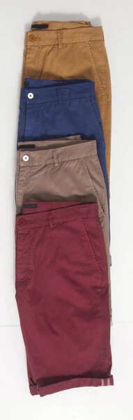 Group of 4 shorts for men isolated, flat style. A stack of men's shorts isolated on a white background. 