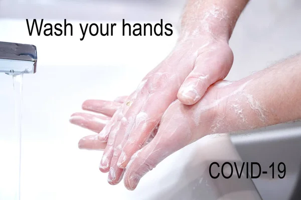 Man wash his hands with soap at home.