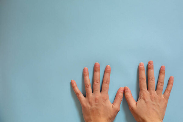 Hand identification. Hygiene during an epidemic. Female hands on a blue background. 