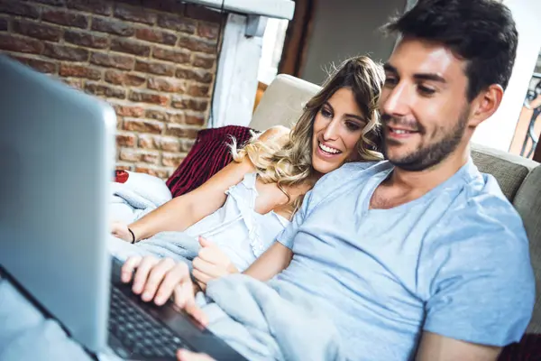 Lovely couple on couch with laptop