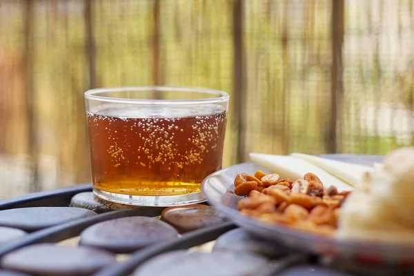 glass of beer and snack on a terrace