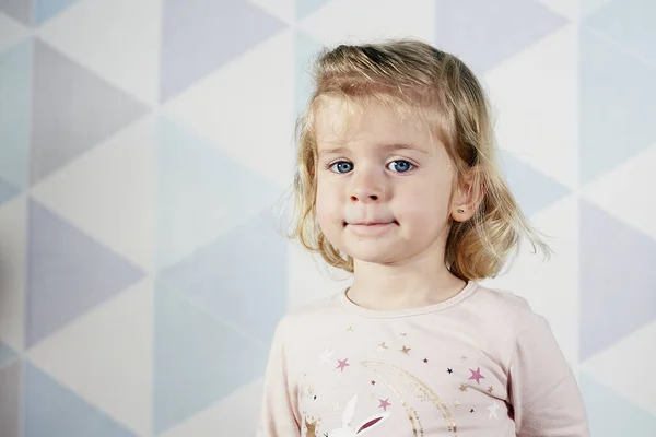 stock image incredulous little girl in blue background