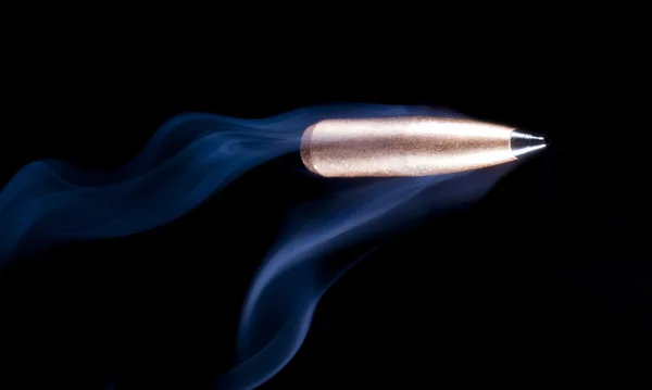 Bullet on black with smoke — Stock Photo, Image
